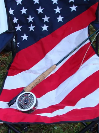 A flag with an american flag and a fly rod.